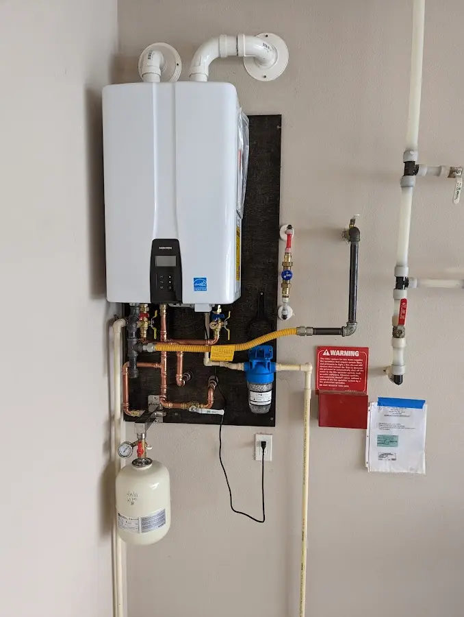 Professional plumber installing copper piping in a Green Tree home